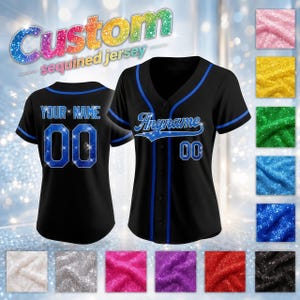 May include: A black baseball jersey with blue trim, featuring the text "Anyname" on the front and "YOUR NAME" with the number "00" on the back. The jersey includes blue sequined lettering and numbers, displayed alongside various colored sequin fabric swatches.