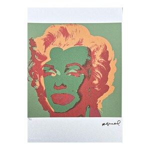 May include: A pop art print depicting Marilyn Monroe in a stylized portrait. The image uses a vibrant colour palette with a green face, red lips and hair, and orange hair. The print is signed in the bottom right corner.