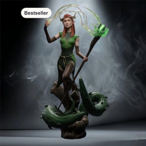 May include: A fantasy figurine of an elf with red hair and pointed ears, wearing a green tunic and brown arm guards. The figure holds a staff topped with a glowing green flower and translucent energy, standing on a base of brown roots and green vines.