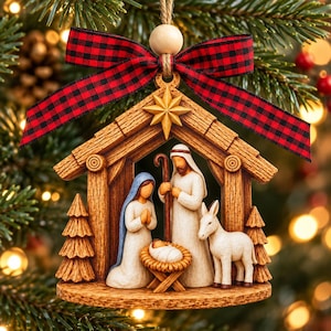 May include: A wooden nativity ornament featuring a stable structure with a star at the peak, topped with a red and black buffalo plaid ribbon. Inside, figures of a person in a blue head covering, a person with a staff, a baby, and a donkey.