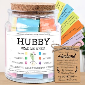 May include: A glass jar with a cork lid filled with colorful Bible verses. The jar has a label that reads "Hubby, Read Me When..." and includes a tag that says "To My Husband." The jar is a thoughtful gift.