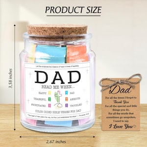 May include: A glass jar with a cork lid, filled with colorful paper notes. The jar has a label that reads "DAD" and "READ ME WHEN..." with various emotions listed. A small tag with "Dad" and a message is tied to the jar. The jar is 3.58 inches tall and 2.67 inches wide.