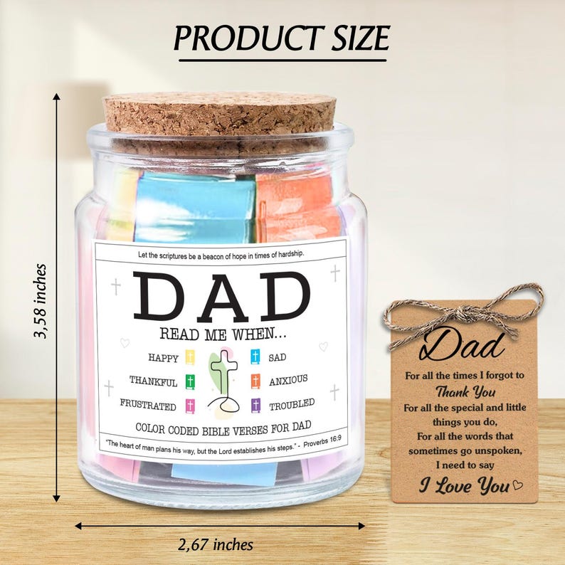 May include: A glass jar with a cork lid, filled with colorful paper notes. The jar has a label that reads "DAD" and "READ ME WHEN..." with various emotions listed. A small tag with "Dad" and a message is tied to the jar. The jar is 3.58 inches tall and 2.67 inches wide.