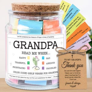 May include: A glass jar with a cork lid, labeled "GRANDPA" and "READ ME WHEN..." with color-coded Bible verses. Includes a tag that says "Thank you" with a cross and a twine bow. The jar contains colorful slips of paper.
