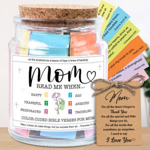 May include: A glass jar with a cork lid, filled with colorful Bible verses. The jar has a label that reads "Mom, Read Me When..." and includes a tag with a message of love. A thoughtful gift.