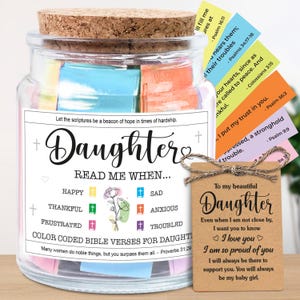 May include: A glass jar with a cork lid filled with colorful Bible verses for a daughter. The jar has a label that reads "Daughter" and "Read Me When..." with various emotions. A small tag reads "To my beautiful Daughter."