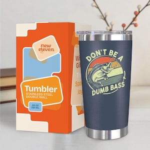 May include: A navy blue stainless steel tumbler with a lid, featuring a graphic of a fish jumping out of the water with the text "DON'T BE A DUMB BASS." The tumbler is 20 oz (591 ml) and comes with an orange box.