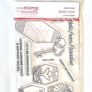 May include: Clear stamp set titled "Paradise Resort" with various designs including a key, lighthouse, and phrases like "Hello from Paradise" and "Happy Retirement". The set is from June 2024.