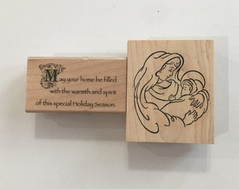 May include: Wooden stamp with a Christmas message: "May your home be filled with the warmth and spirit of this special Holiday Season."  The second stamp features a line drawing of Mary holding baby Jesus.