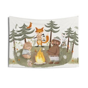 Pode incluir: Uma tape&ccedil;aria com uma cena florestal caprichosa com animais de desenho animado ao redor de uma fogueira. Uma raposa segura uma lanterna, um urso assa marshmallows, e um ouri&ccedil;o e um esquilo tamb&eacute;m est&atilde;o presentes. A obra de arte tem um estilo suave de aquarela com tons verdes e marrons.
