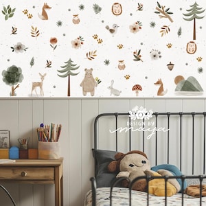 May include: A charming wall mural with a woodland theme, showcasing watercolour illustrations of animals and plants. The design includes a bear, fox, deer, and owl, set against a speckled white backdrop. Ideal for a nursery or children's room.