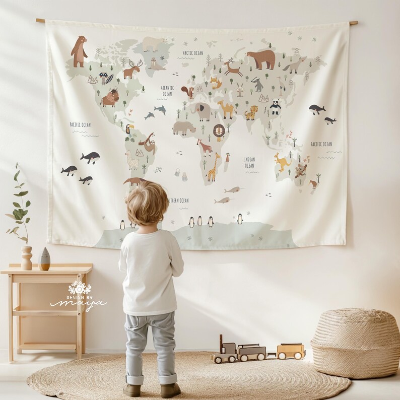 Pode incluir: Uma tape&ccedil;aria de mapa-m&uacute;ndi bege com animais e continentes ilustrados. O mapa apresenta uma variedade de animais, incluindo ursos, veados e elefantes. O texto "Oceano Pac&iacute;fico", "Oceano Atl&acirc;ntico" e "Oceano &Iacute;ndico" &eacute; vis&iacute;vel. Uma crian&ccedil;a est&aacute; em frente ao mapa.