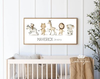 May include: A framed watercolor print featuring a zebra, monkey, tiger, giraffe, lion, and koala. The animals are depicted in a line, with the name "Maverick James" below. The frame is a light brown color.