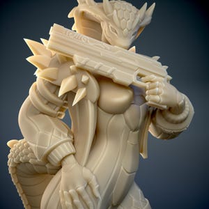 May include: A beige figurine of a humanoid cobra-like creature holding a futuristic weapon. The figure has detailed armour, scales, and sharp spikes. The weapon is held at the ready, suggesting a combat theme.