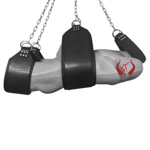 May include: Black leather restraints suspended by silver chains. The restraints are designed to secure a body part. The image has a white background. Red devil horns are drawn on the body part.