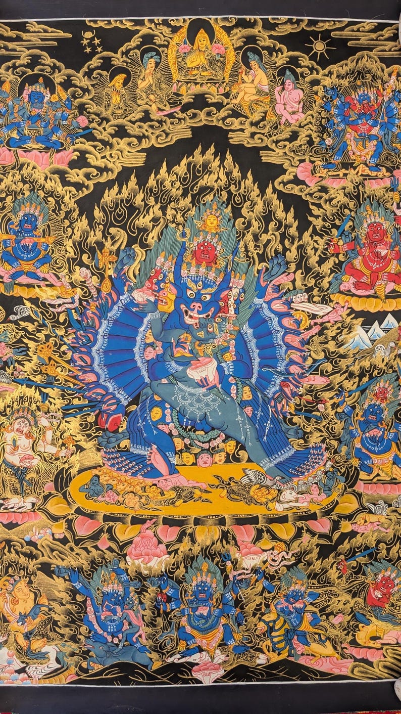 May include: A colorful Tibetan Buddhist Thangka painting depicting a deity with multiple arms and heads, surrounded by other figures and symbols. The painting is done in a traditional style with vibrant colors and intricate details.