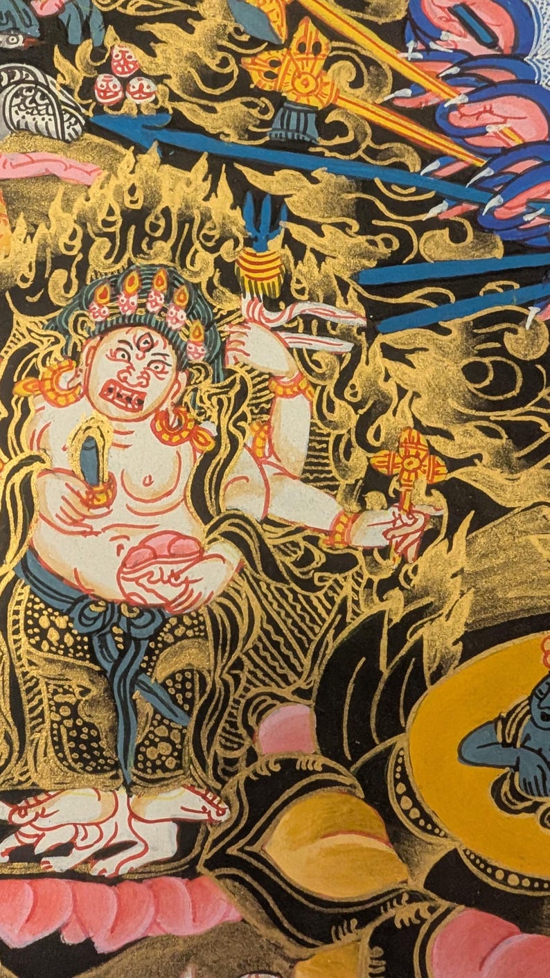 May include: A detailed painting of a deity with multiple arms, holding various objects. The deity is depicted with a fierce expression and a crown of flames. The painting is done in a traditional style with vibrant colors and intricate details.
