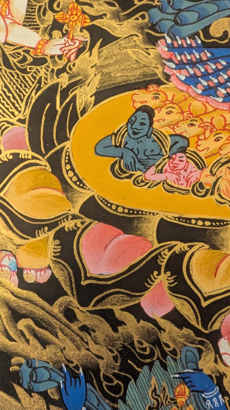 May include: A detailed painting of a deity with a blue body and a yellow halo, surrounded by smaller figures. The deity is seated on a lotus flower with pink petals and a gold center. The background is black with gold accents.