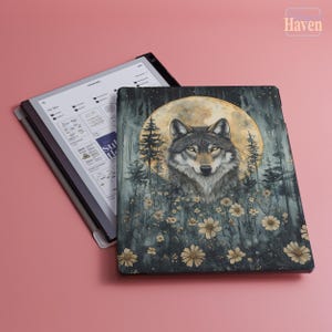 May include: A tablet case featuring a detailed illustration of a wolf against a backdrop of a full moon, trees, and flowers. The color palette includes shades of gray, green, and yellow. The tablet is open, displaying a digital interface.