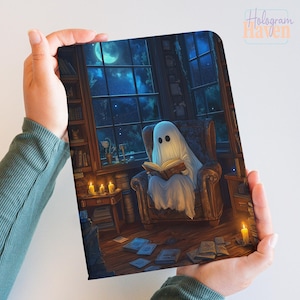 May include: A digital art print featuring a ghost reading a book in a cozy library setting. The ghost is seated in a plush armchair, illuminated by candlelight and a large window with a moonlit view. The print has the text "Hologram Haven".