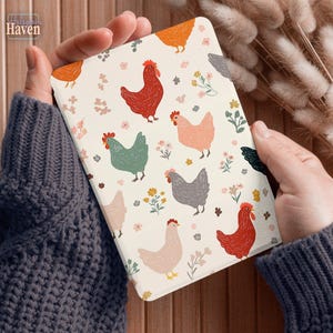 May include: A cream-colored tablet case featuring a repeating pattern of colorful chickens and floral accents. The chickens are in shades of red, green, gray, and peach. The case has the text "Hallsgam Haven" in the upper left corner.