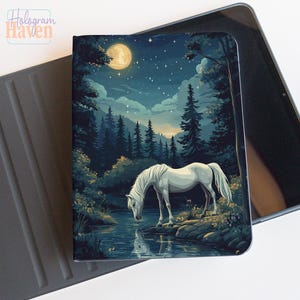 May include: A tablet case featuring a serene nighttime forest scene with a white horse drinking from a lake under a full moon. The case has a dark blue and green color palette, with the Hologram Haven logo in the upper left corner.