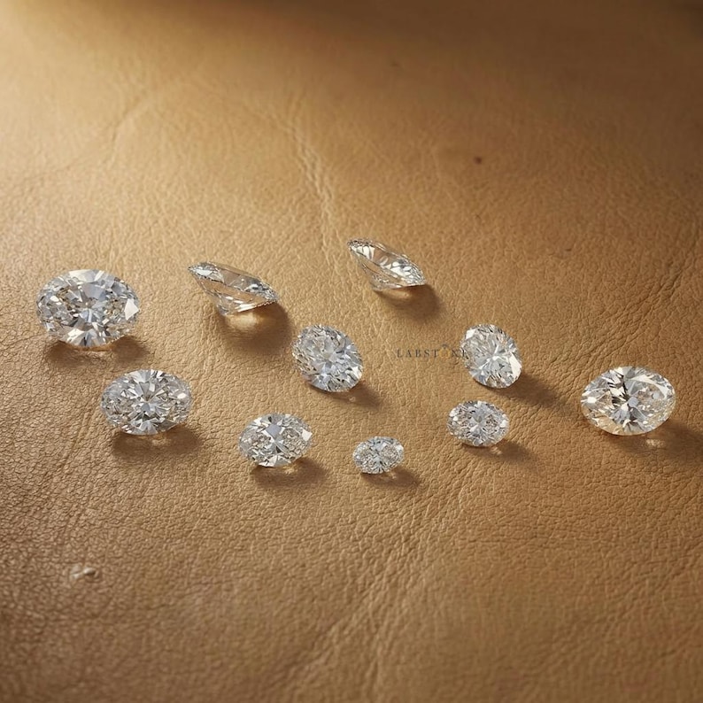 Oval cut lab grown diamonds arranged by size from small to large, diamond size comparison for custom engagement ring selection and jewelry making