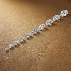 IGI certified oval cut lab grown diamonds displayed in vertical size comparison, loose diamonds for custom engagement rings and bridal jewelry