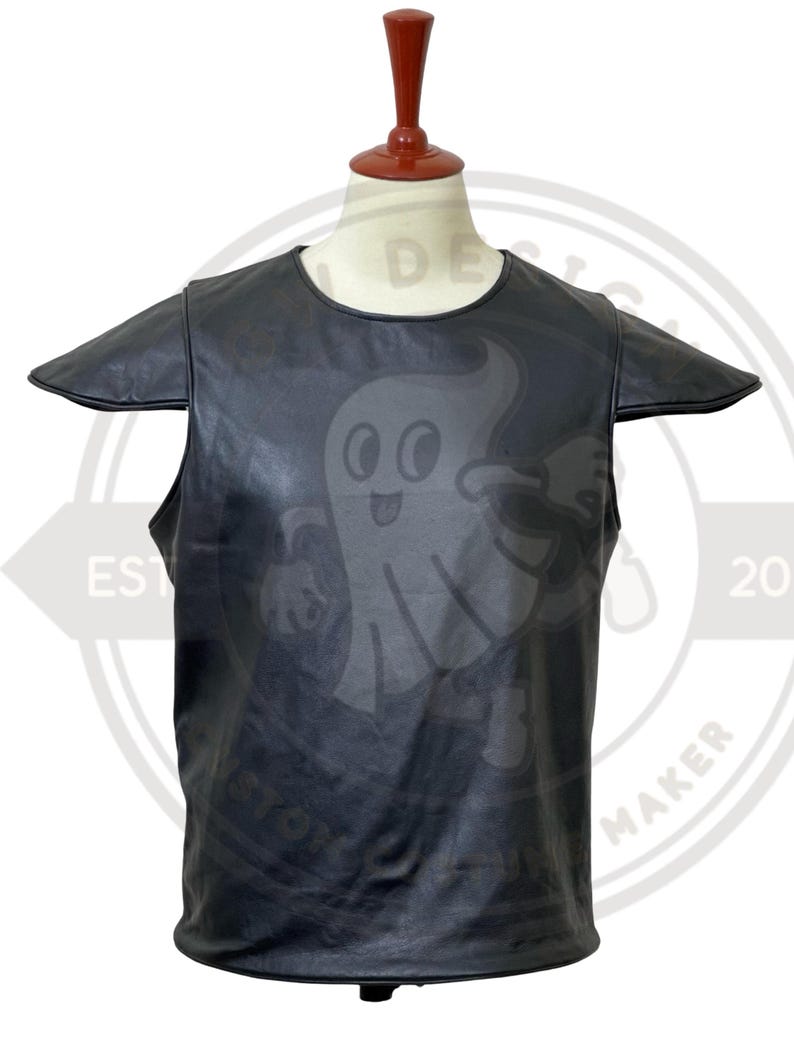 May include: Black leather vest with a cartoon ghost graphic. The vest has short sleeves and a round neckline. The ghost graphic is centered on the front of the vest. The vest is displayed on a mannequin.
