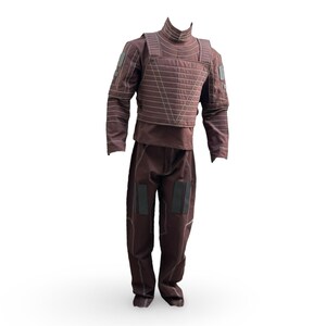 May include: A brown tactical suit, comprising a high-collared top, quilted vest, and matching trousers. The suit has reinforced patches on the shoulders, elbows, and knees. The stitching is a lighter brown, creating a contrast against the darker fabric.