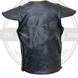 May include: Black leather vest with a cartoon ghost graphic on the back. The vest has short sleeves and a round neckline. The text "EST 2018" and "CUSTOM ONE MAKER" are visible on the sides.