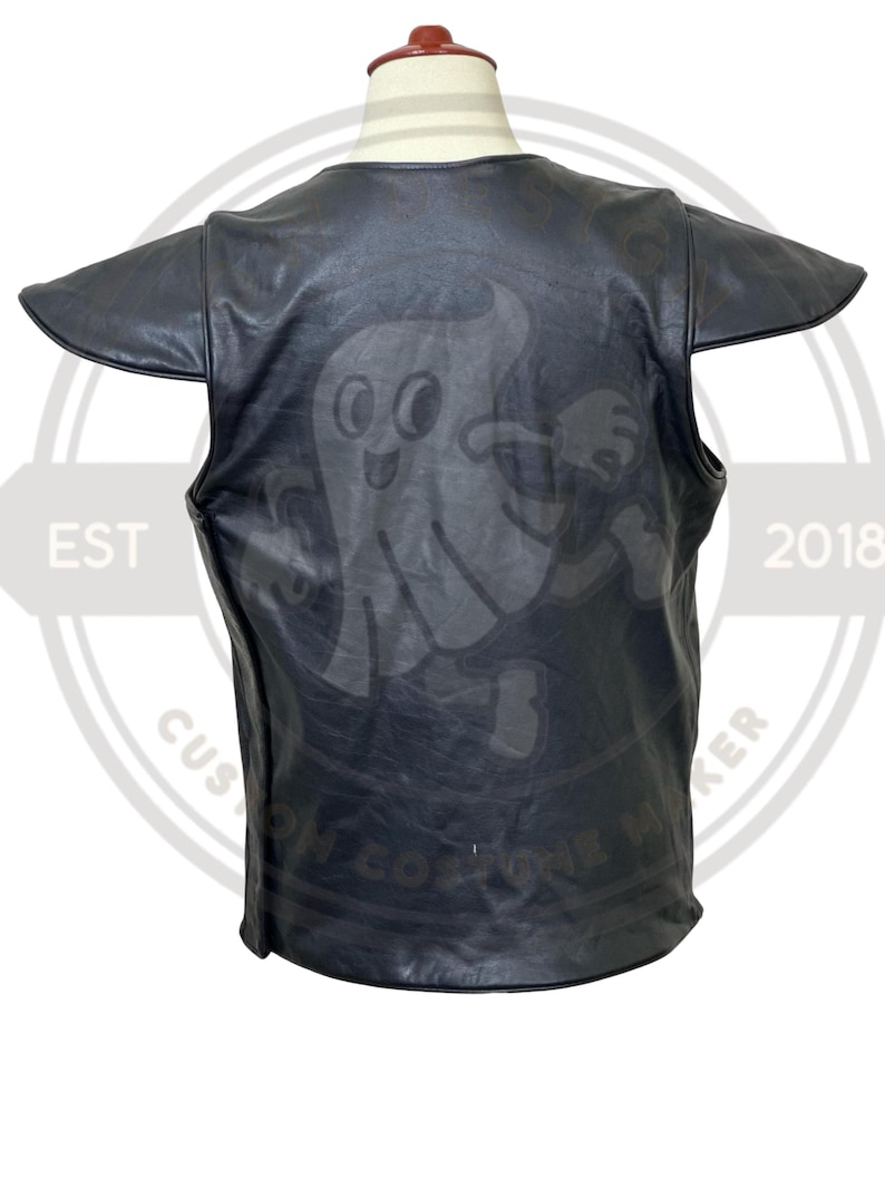 May include: Black leather vest with a cartoon ghost graphic on the back. The vest has short sleeves and a round neckline. The text "EST 2018" and "CUSTOM ONE MAKER" are visible on the sides.