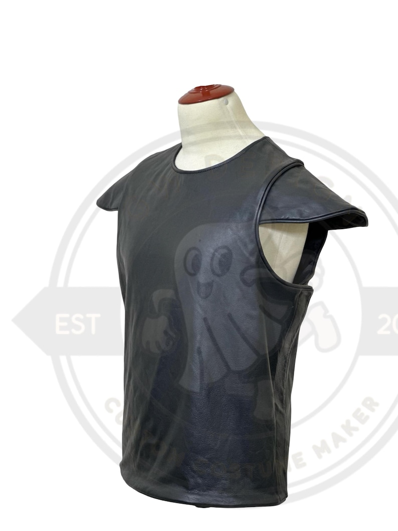 May include: Black leather vest with shoulder accents, displayed on a mannequin. The vest has a round neckline and a sleeveless design. The leather appears to be smooth and has a slight sheen. The vest is likely part of a costume or cosplay ensemble.