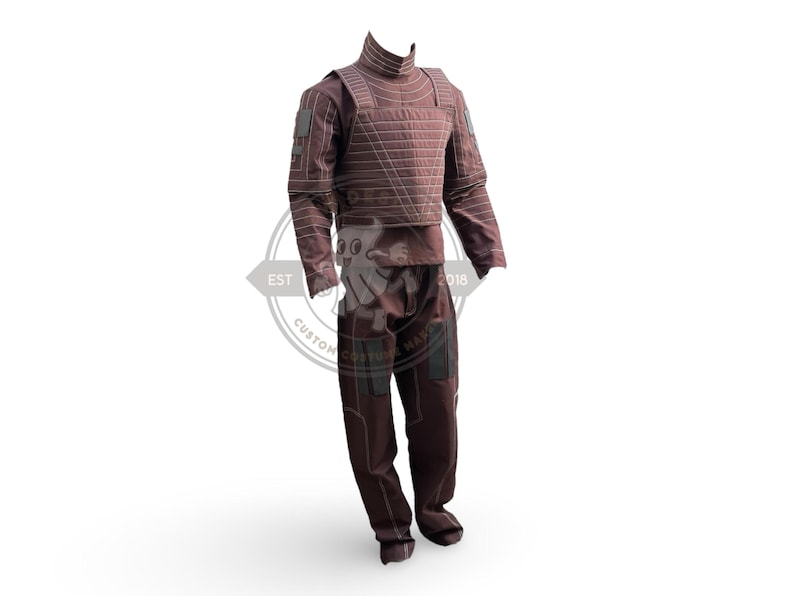 May include: A maroon costume with a high collar, long sleeves, and matching trousers. The top features a quilted design with rectangular patches on the shoulders and sleeves. The trousers have pockets on the thighs. Ideal for cosplay or costume events.