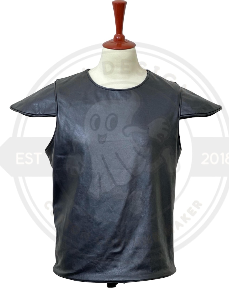 May include: Black leather top with a round neckline and short sleeves. A cartoon ghost graphic is subtly printed on the front. The top is displayed on a mannequin.