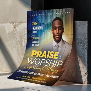 May include: A poster advertising a church event, featuring a man in a suit. The poster includes the words "Praise & Worship" and "Inspirational Message." The date of the event is November 25th.