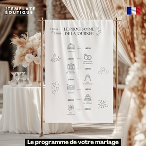Peut inclure: Une bannière blanche pour un programme de mariage avec du texte et des illustrations noirs, dont une voiture, des alliances, un appareil photo, des flûtes à champagne et un gâteau. La bannière est tenue par un support en métal doré. Texte : "Olivia & Liam".