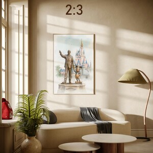 May include: A framed watercolor print featuring a statue of a man and Mickey Mouse in front of a castle. The print is displayed on a wall above a beige sofa. The text "2:3" is in the upper center of the image.