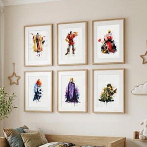 May include: Six framed watercolor prints of Disney villains hang on a wall. The artwork features characters like Cruella de Vil, Gaston, and the Queen of Hearts. Each print is in a wooden frame, adding a classic touch to the colorful illustrations.
