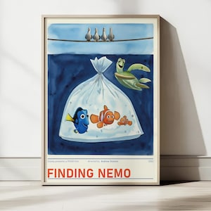 May include: A framed watercolour print of the film "Finding Nemo." The artwork shows characters Dory, Nemo, and Marlin in a plastic bag, with Crush the sea turtle swimming nearby. Above, four birds perch on a wire against a blue sky.
