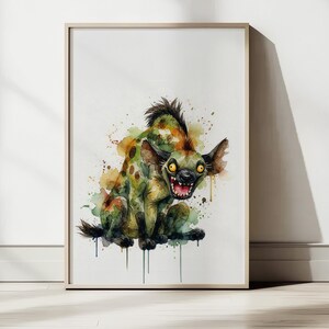 May include: Watercolor art print of a hyena with a menacing expression. The hyena is depicted in shades of green, brown, and yellow, with a spotted pattern. The artwork is framed in a light wood frame and is suitable for wall decor.