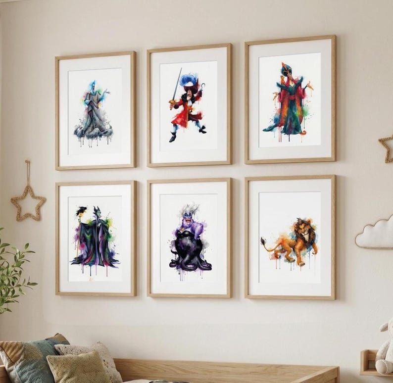 May include: Six framed watercolor prints featuring Disney villains. The artwork includes Hades, Captain Hook, Jafar, Maleficent, Ursula, and Scar. Each print has a white background and a wooden frame, with colorful paint splatters.