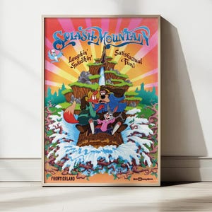 May include: A framed poster featuring the Splash Mountain ride. The artwork depicts cartoon characters on a log flume ride with the text "Splash Mountain" in a blue and orange font. The poster has a colorful, vintage style.