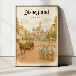 May include: A framed vintage-style Disneyland Anaheim poster. The artwork depicts a horse-drawn trolley, a marching band, and the iconic Sleeping Beauty Castle. The poster has a warm, nostalgic color palette, evoking a sense of classic Americana.