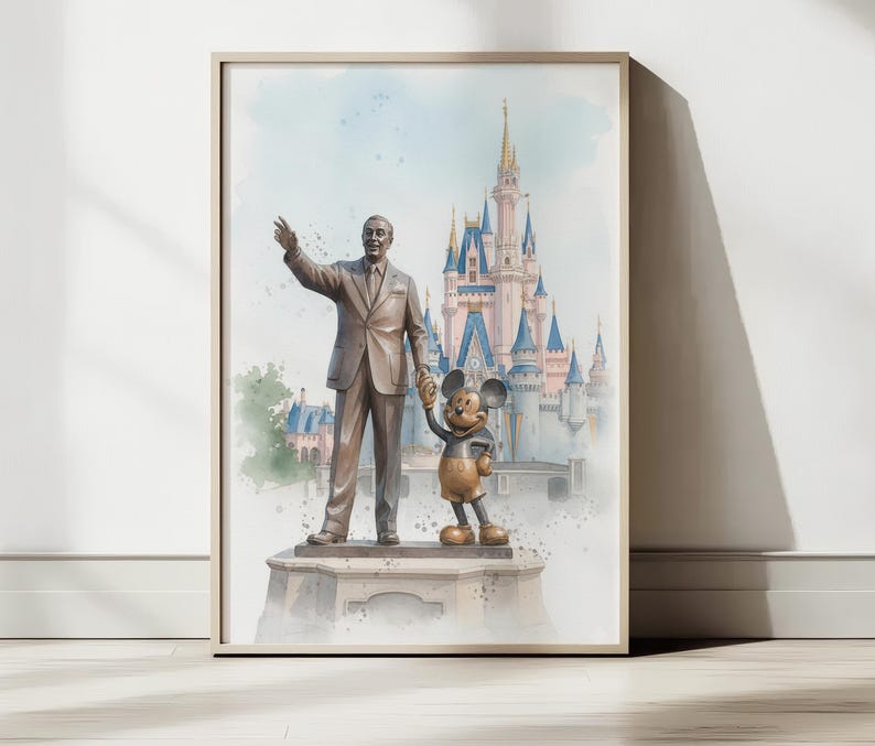 May include: Framed watercolor print featuring a statue of a man and Mickey Mouse in front of a castle. The artwork has a soft, pastel color palette with a light blue sky and a beige frame.