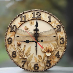 May include: A decorative wall clock with a cream-coloured face featuring a dragonfly and floral design. The clock has black hands, a red second hand, and bronze-coloured numerals. The clock's outer rim is bronze-coloured with a detailed pattern.