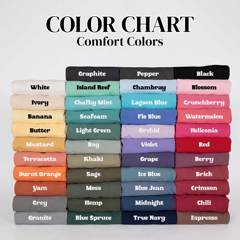 May include: A color chart for Comfort Colors featuring a grid of folded fabric swatches in various shades. The text at the top reads COLOR CHART Comfort Colors, followed by rows of labeled colors including White, Ivory, Banana, Butter, Mustard, Terracotta, Burnt Orange, Yam, Grey, Granite, Graphite, Pepper, Black, Island Reef, Chalky Mint, Seafoam, Light Green, Bay, Khaki, Sage, Moss, Hemp, Blue Spruce, Chambray, Lagoon Blue, Flo Blue, Orchid, Violet, Grape, Ice Blue, Blue Jean, Midnight, True Navy, Blossom, Crunchberry, Watermelon, Heliconia, Red, Berry, Brick, Crimson, Chili, and Espresso.
