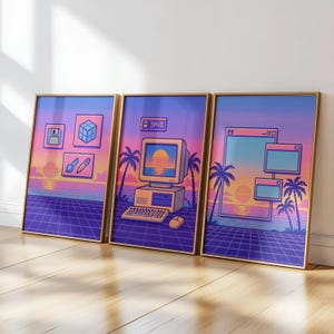 May include: Set of three framed art prints with a retro 80s aesthetic. Each print features pixelated graphics of a sunset, palm trees, and computer-related icons. The frames are a warm gold color, and the overall theme is nostalgic.