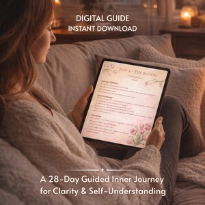 May include: A person holding a tablet displaying a digital guide titled "DAY 3 - THE BLOOM." The screen shows text and floral illustrations. The image also includes the text "DIGITAL GUIDE INSTANT DOWNLOAD" and "A 28-Day Guided Inner Journey for Clarity & Self-Understanding."
