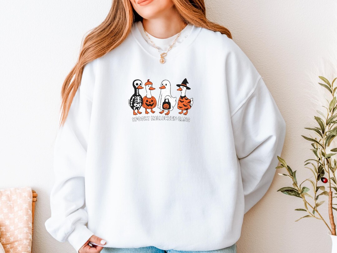 Spooky Halloween Hoodie with Pumpkin Faces, Unisex Sweatshirt, Cozy Fall Fashion, Halloween Gift, Casual Autumn Wear